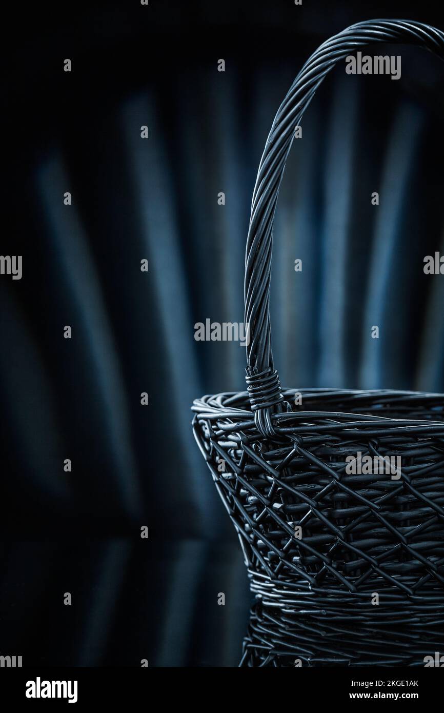 empty wicker basket on abstract black background Stock Photo