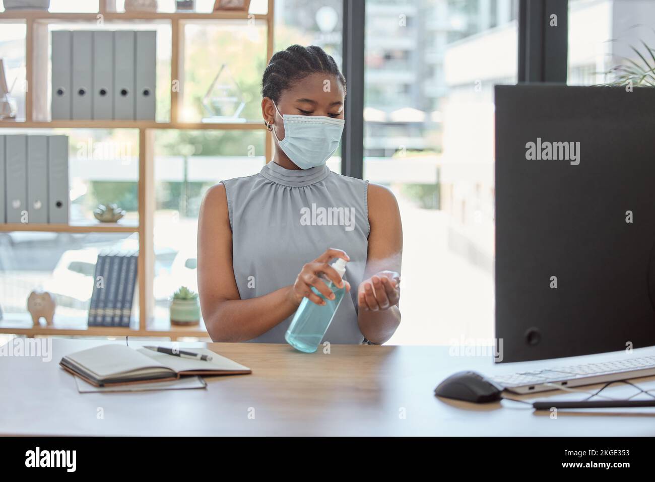 Covid, mask and hand sanitizer with a business black woman cleaning