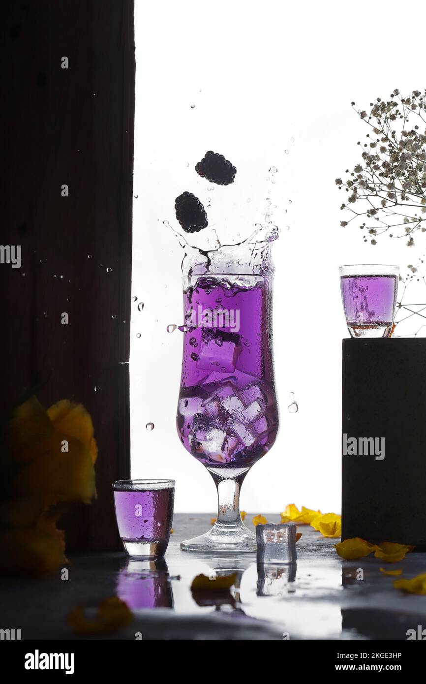 blackberry juice with ice splash and floating berries on white background Stock Photo Alamy