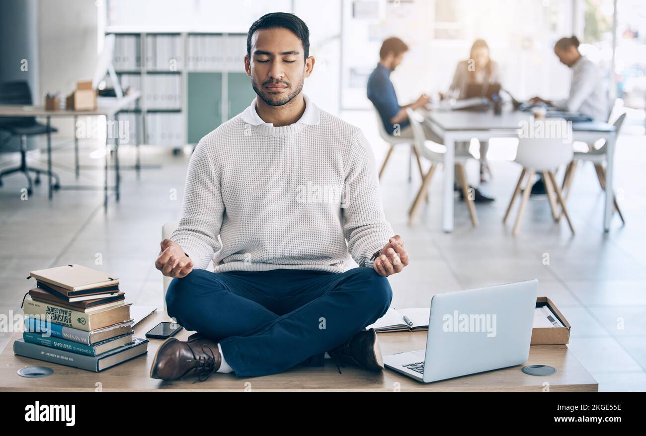 Meditation, relax or businessman with laptop, books or zen peace in office desk for work mindset, wellness or mental health. Corporate, employee or Stock Photo