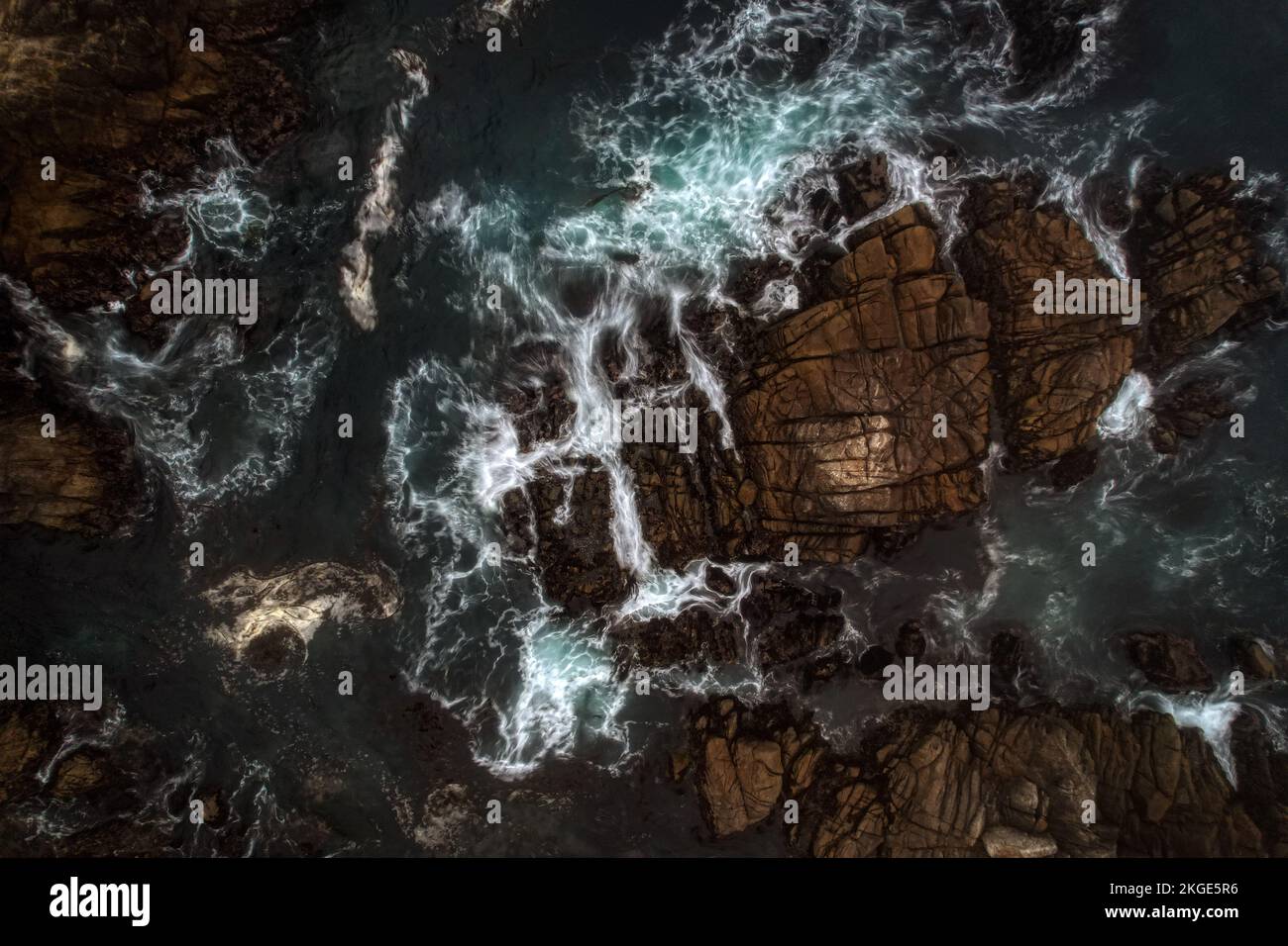 An aerial view of sea waves breaking rocky beach Stock Photo - Alamy