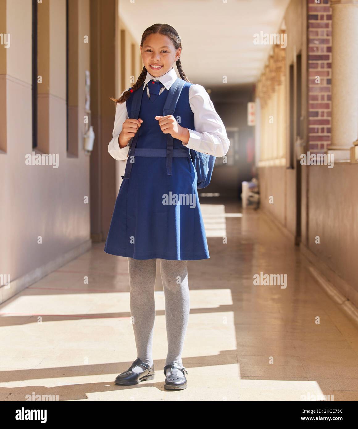 School, student girl and in uniform for education, class and happy with smile, confident and outdoor. Portrait, female pupil or learner with happiness Stock Photo
