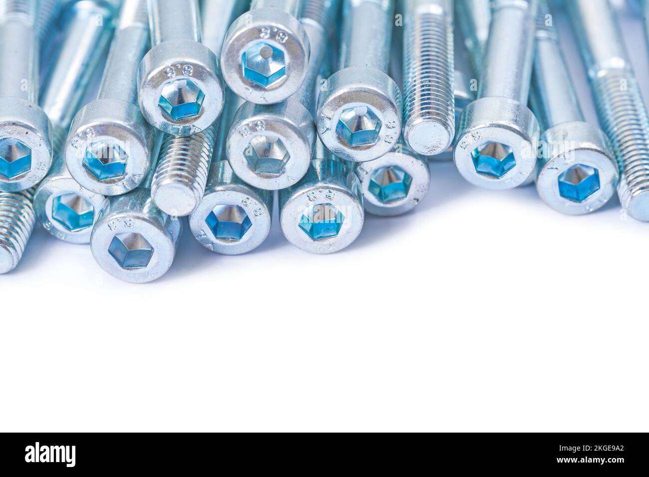 industrial background stack of bolts isolated Stock Photo