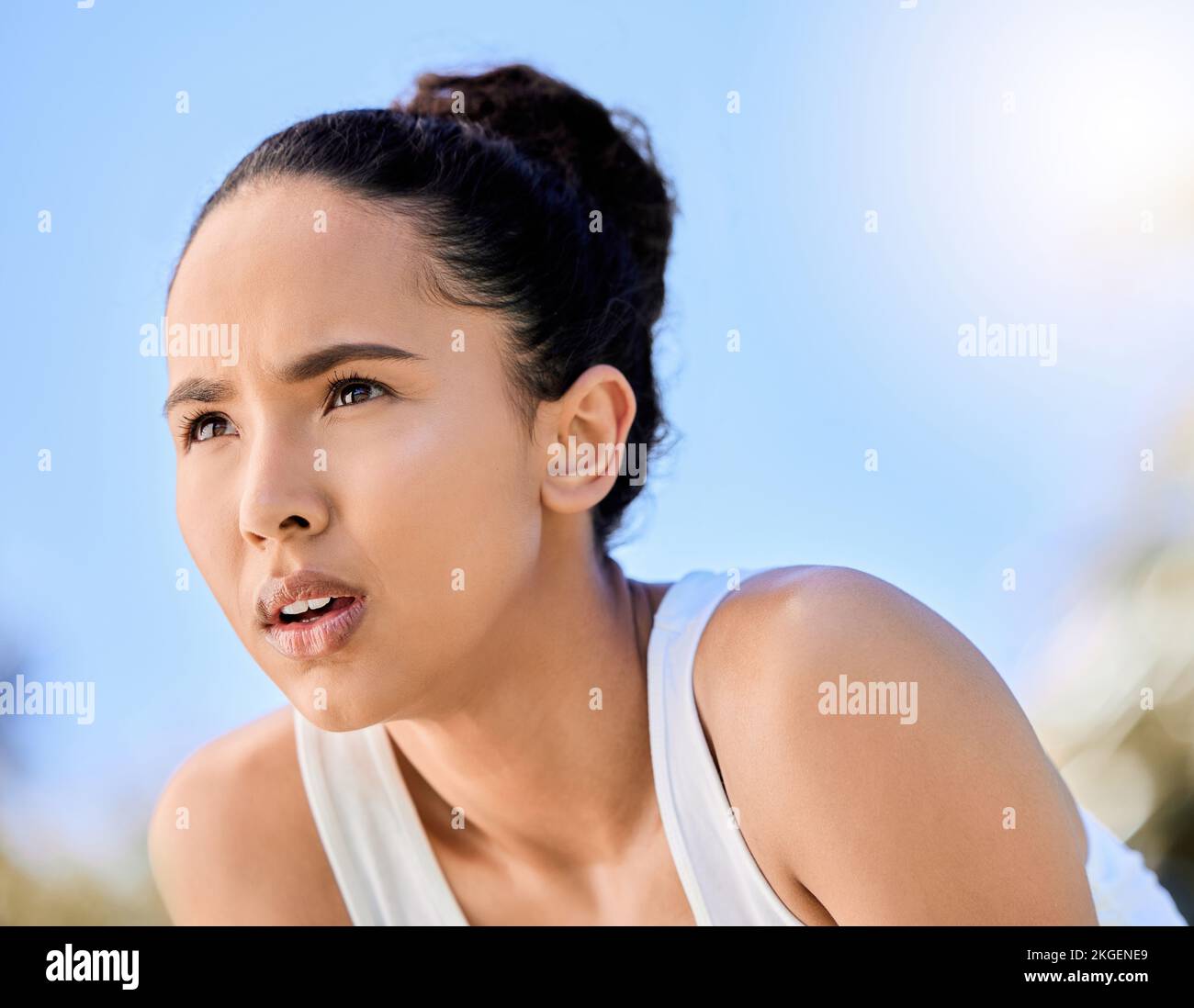 Thinking, focus and woman outdoor, challenge, breathing and tired face, exercise or fitness. Serious female athlete training with mental motivation Stock Photo