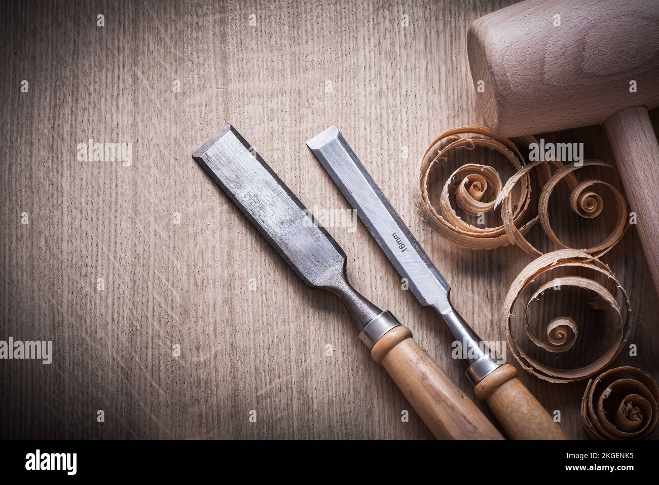 Planing chips wooden mallet carpenter’s flat chisels on wood surface construction concept. Stock Photo
