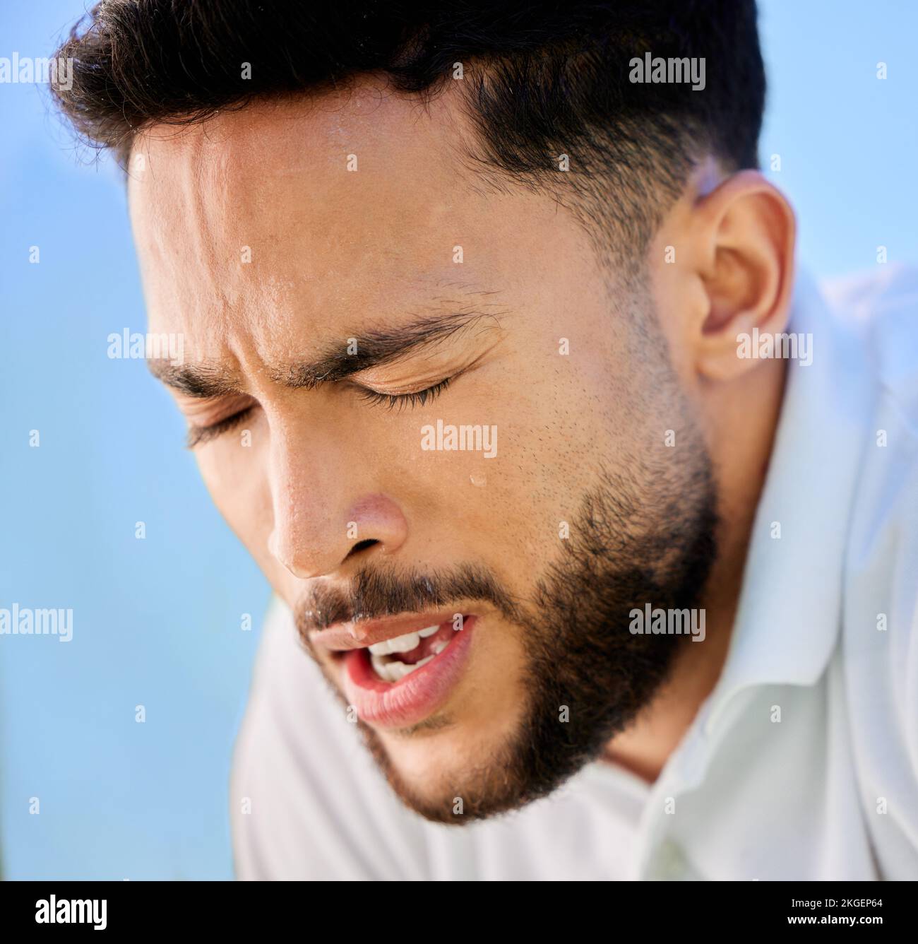 Fitness face, tired or tennis man for fatigue from exercise, training or sport wellness outdoor with sweat. Health, breathing or athlete relax during Stock Photo