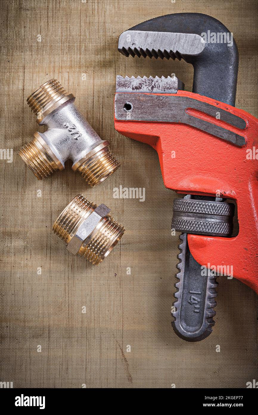 Pipe wrench plumbing fixtures on mesh filter grid Stock Photo Alamy
