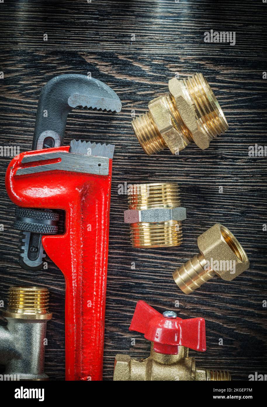 Plumbing adjustable wrench threaded pipe fittings water valve on wooden