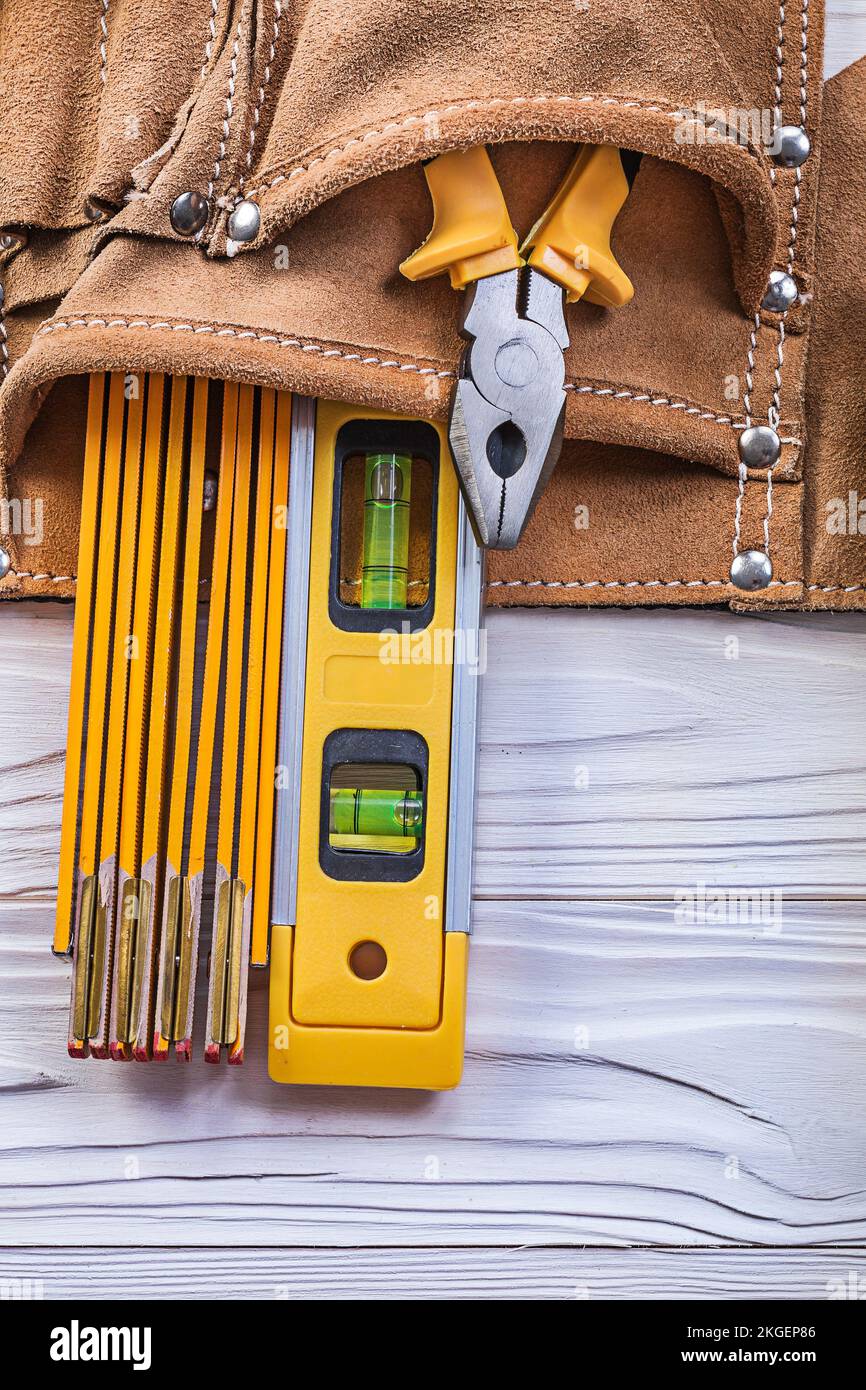 Pliers wooden meter construction level tool belt on wood board ...
