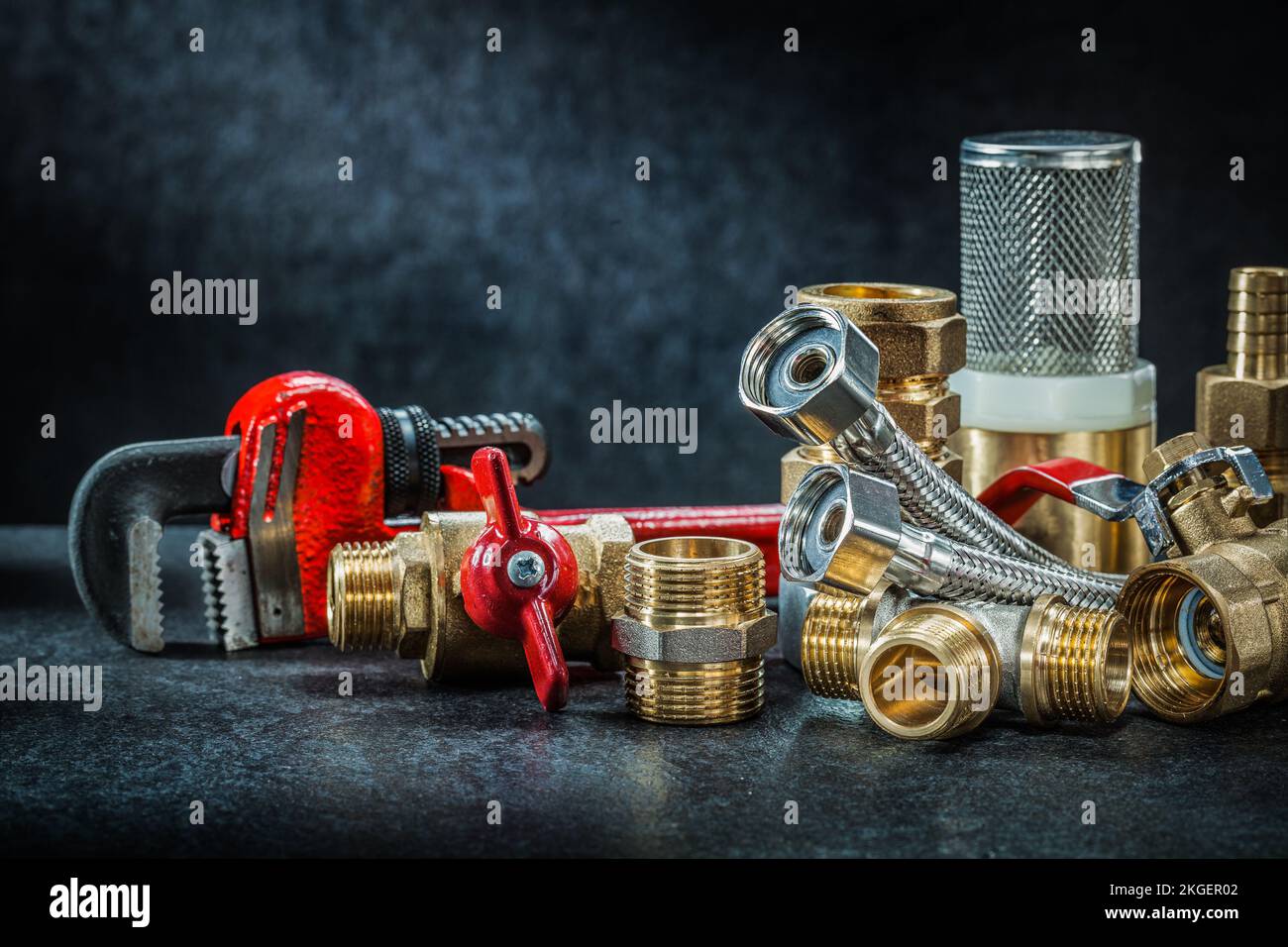 plumbing brass pipe connectors on dark background Stock Photo