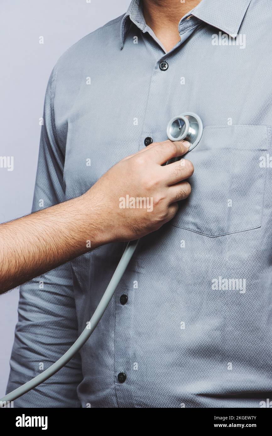 High-Resolution stock photo of doctor's routine check-up. Close-up of a doctor examining the patient's vital chest with the stethoscope. Routine care Stock Photo