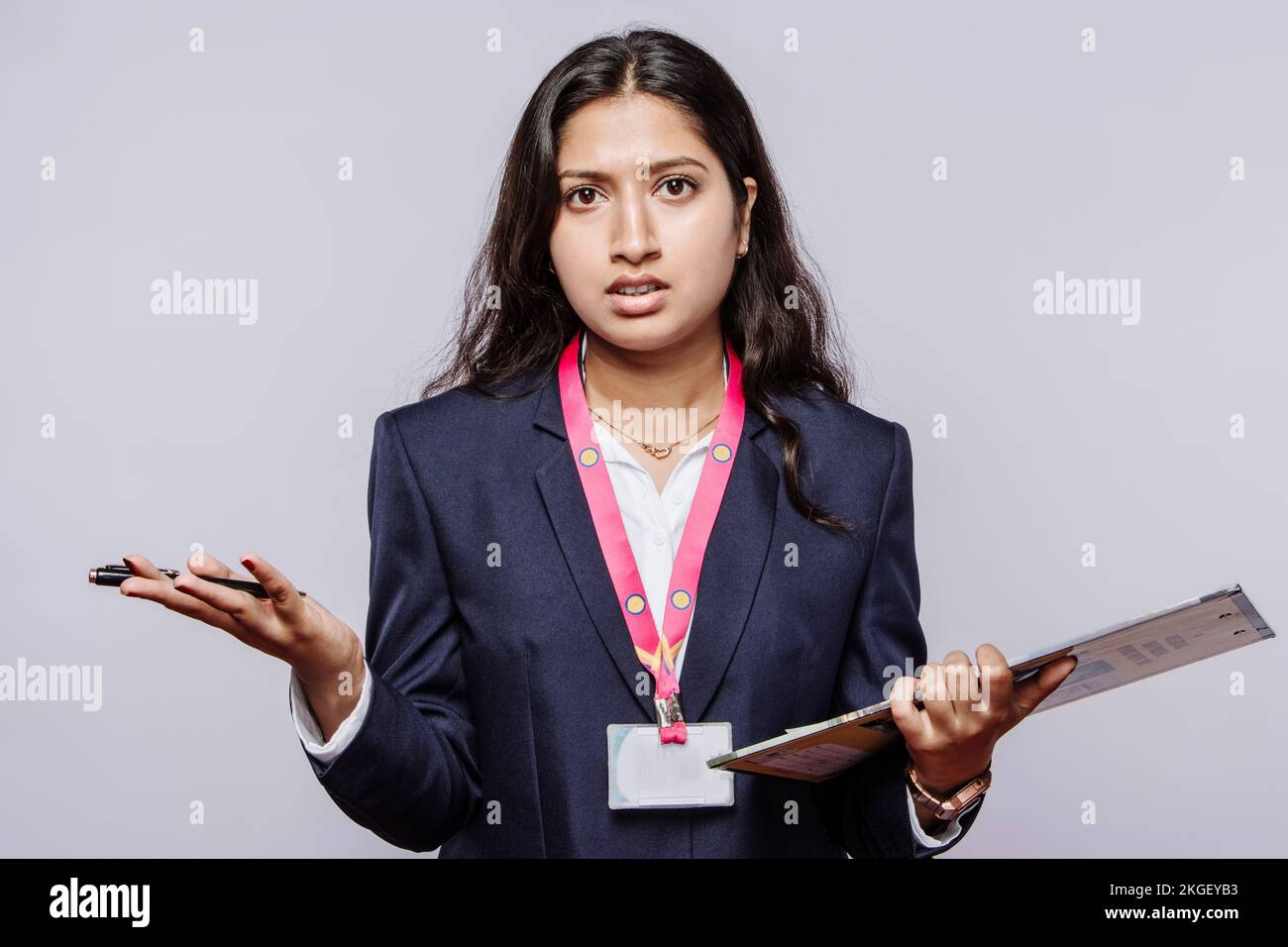 Angry distressed millennial Indian female employee looking at the camera frustrated by a latecomer or a problem. Unhappy young ethnic woman shocked an Stock Photo