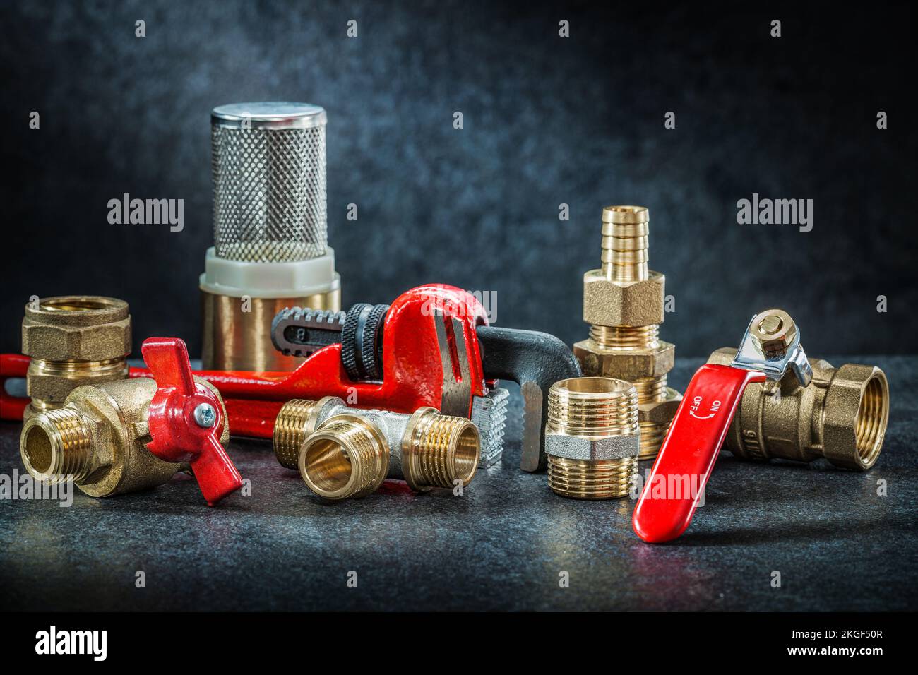 set of plumbing pipe connectors on dark background Stock Photo