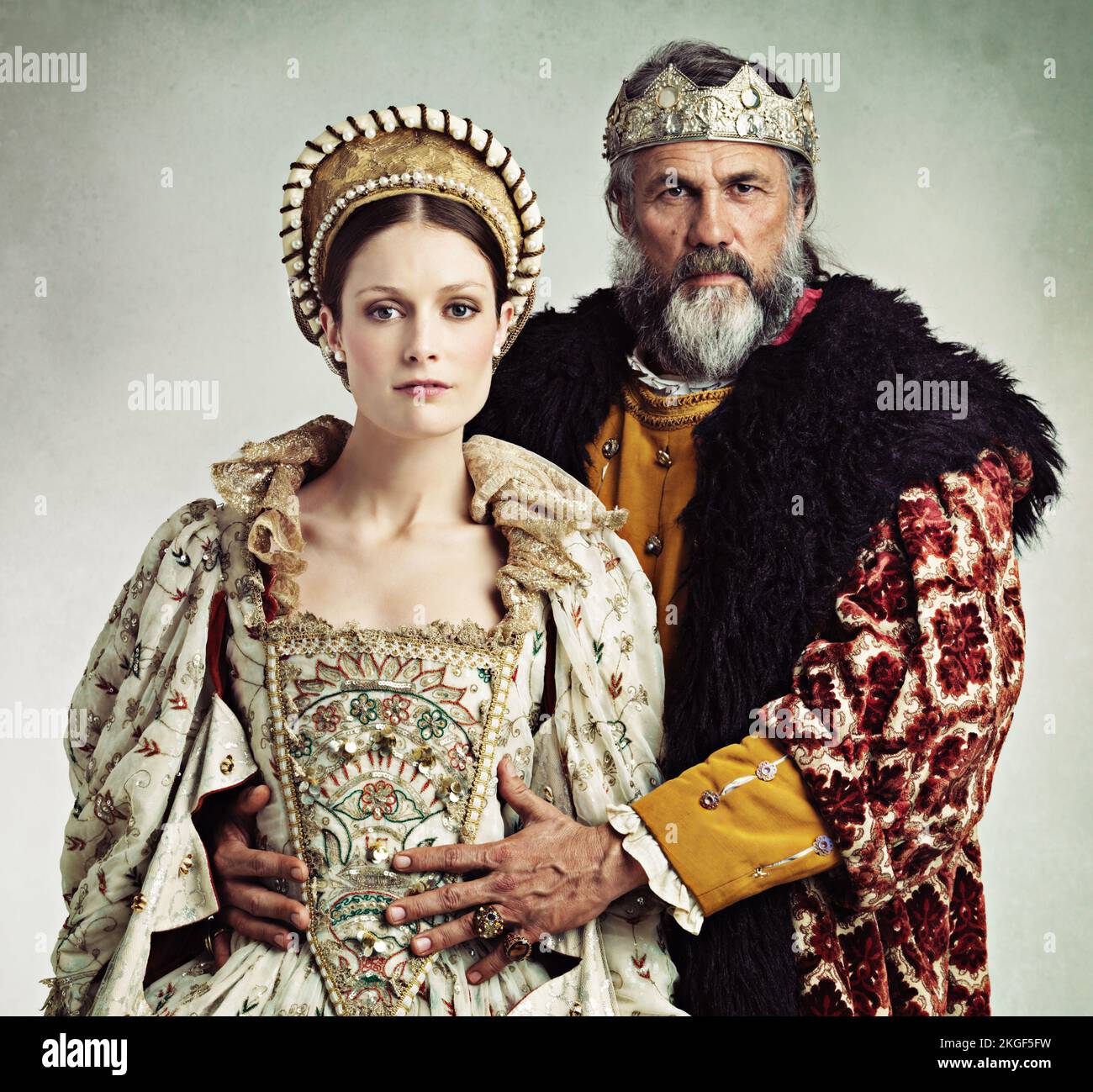 Who is actually in charge here... To be continued.Studio portrait of a stern-looking king and queen. Stock Photo