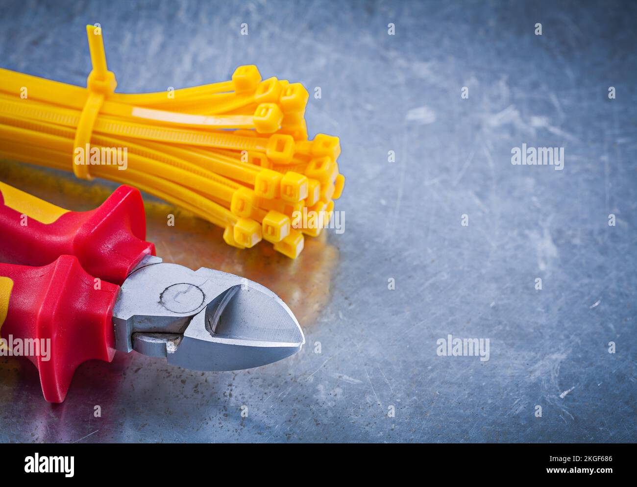 Sharp nippers cable ties on metallic background construction concept. Stock Photo