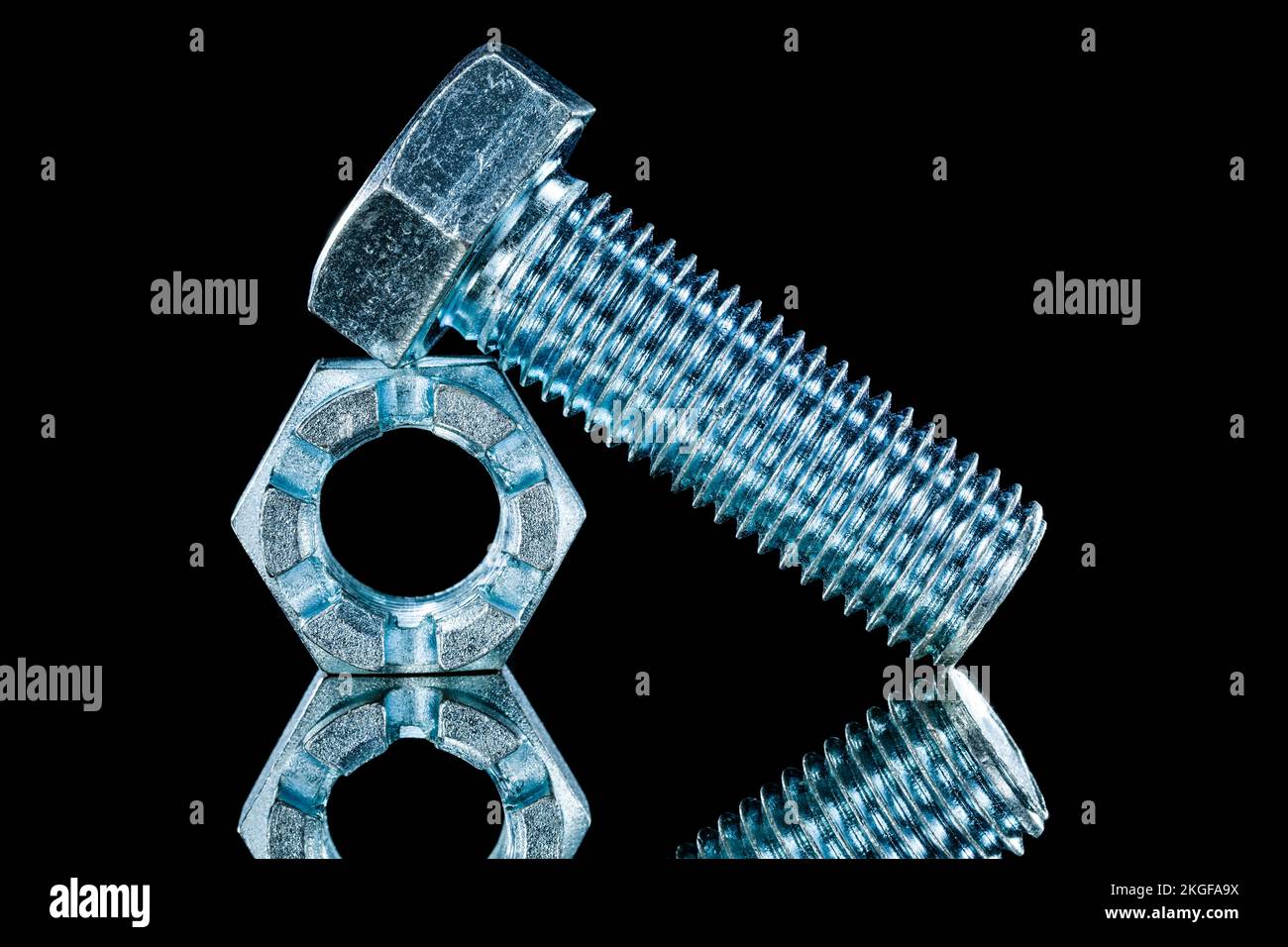 Threaded crown nuts bolts on black background horizontal view. Stock Photo