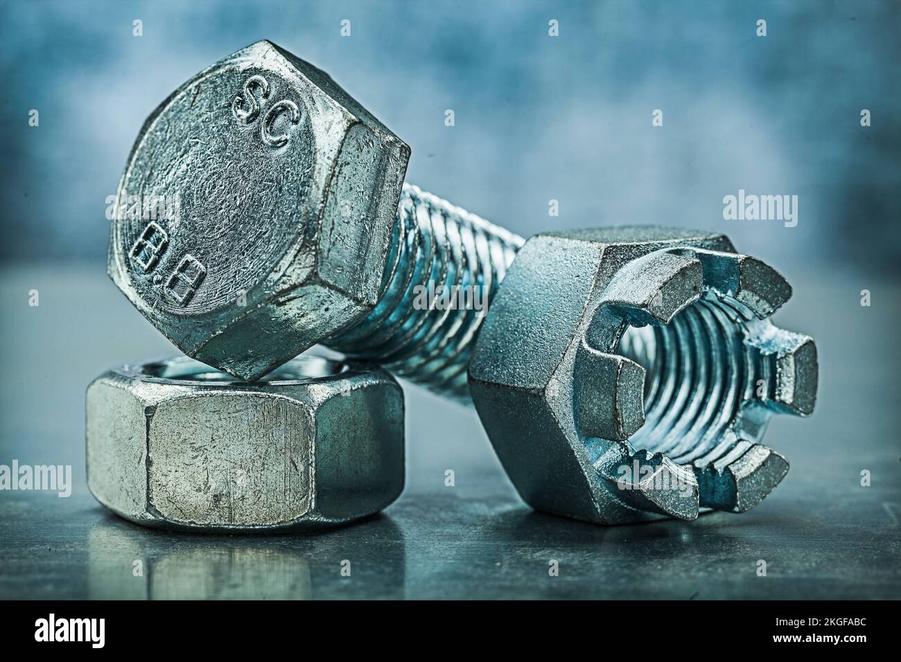 threaded crown nuts and bolt on metalic background Stock Photo Alamy