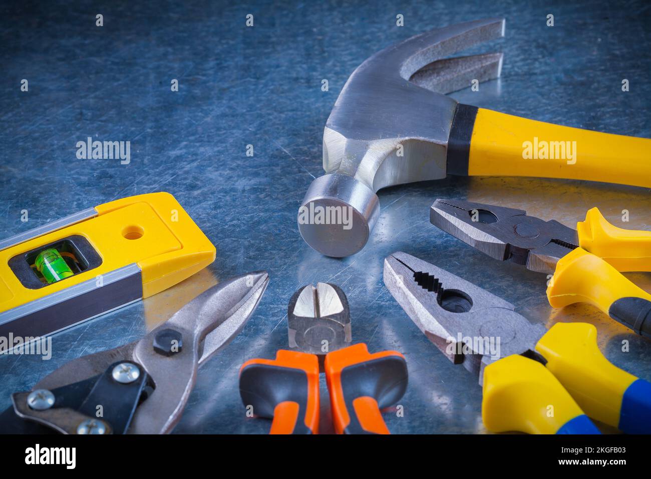 Tin snips gripping tongs nippers hammer and construction level on