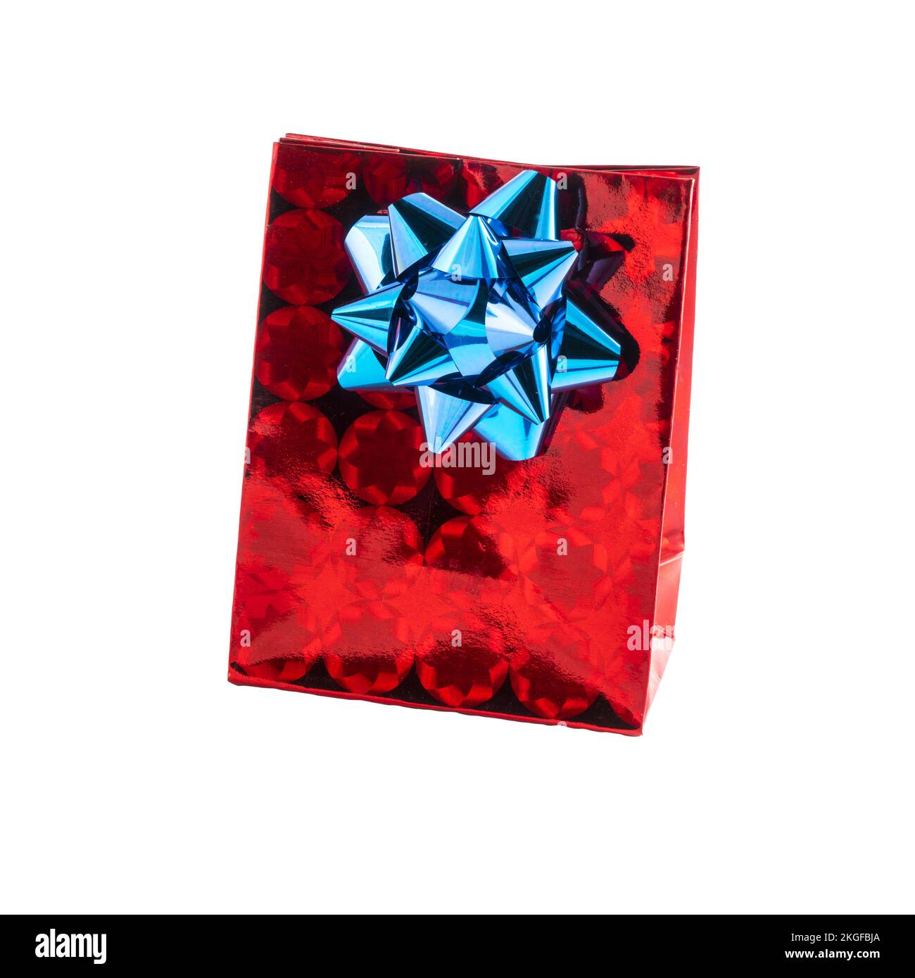 a red gift bag with a bow on a transparent surface Stock Photo