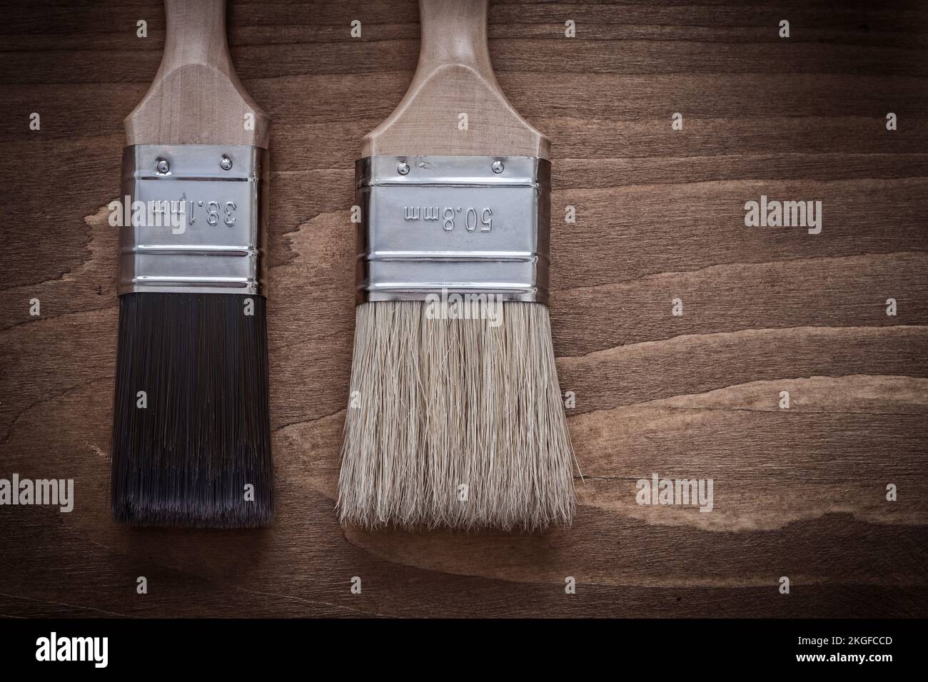 Two paint brushes with wood handles and bristle construction concept ...