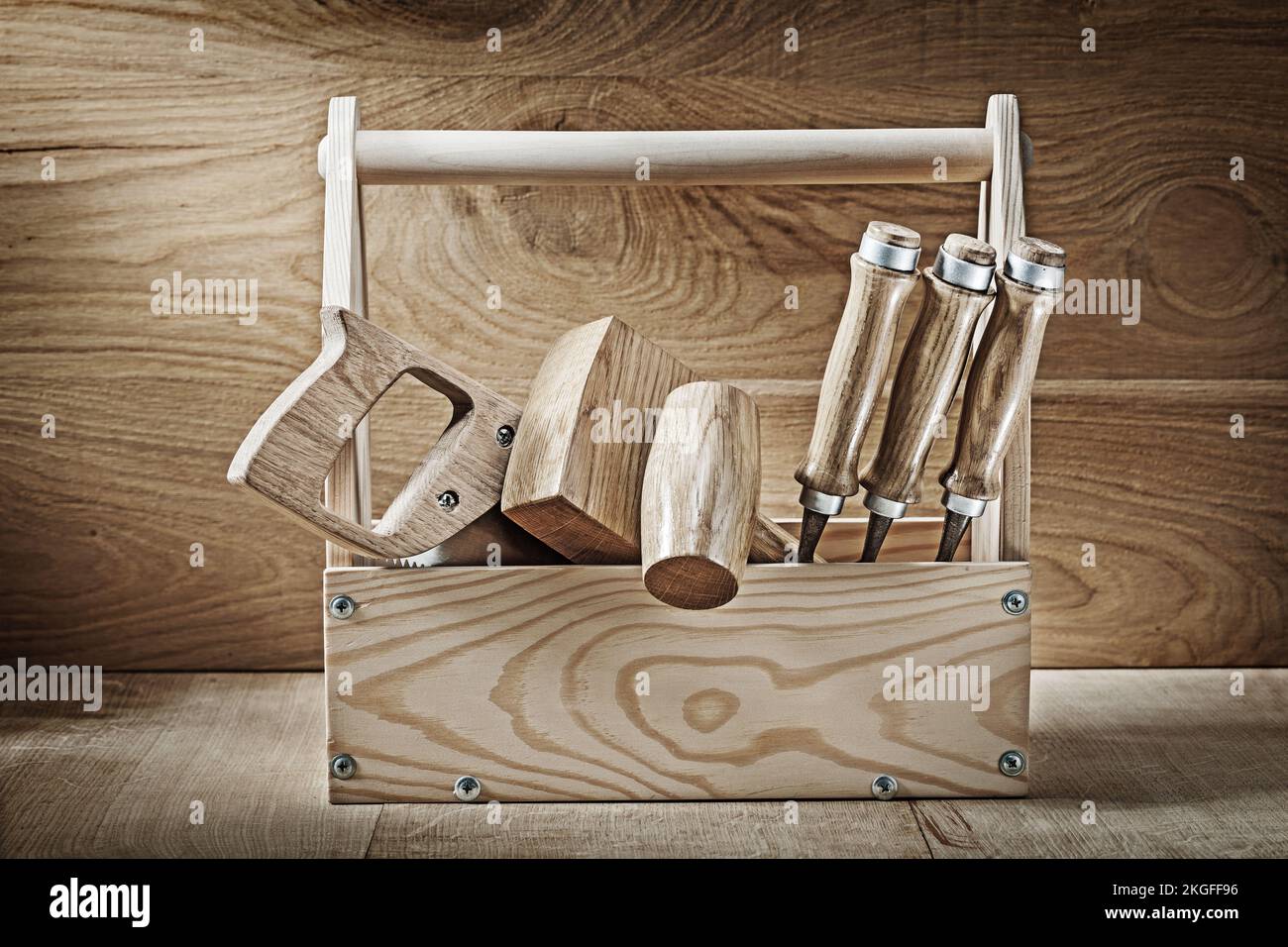 vintage carpenter tools in wooden box on wood background Stock Photo