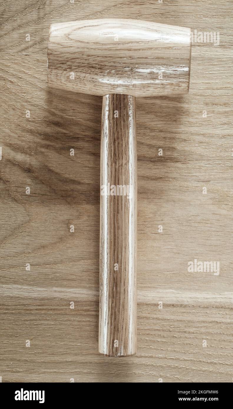 Wooden mallet on wood board. Stock Photo