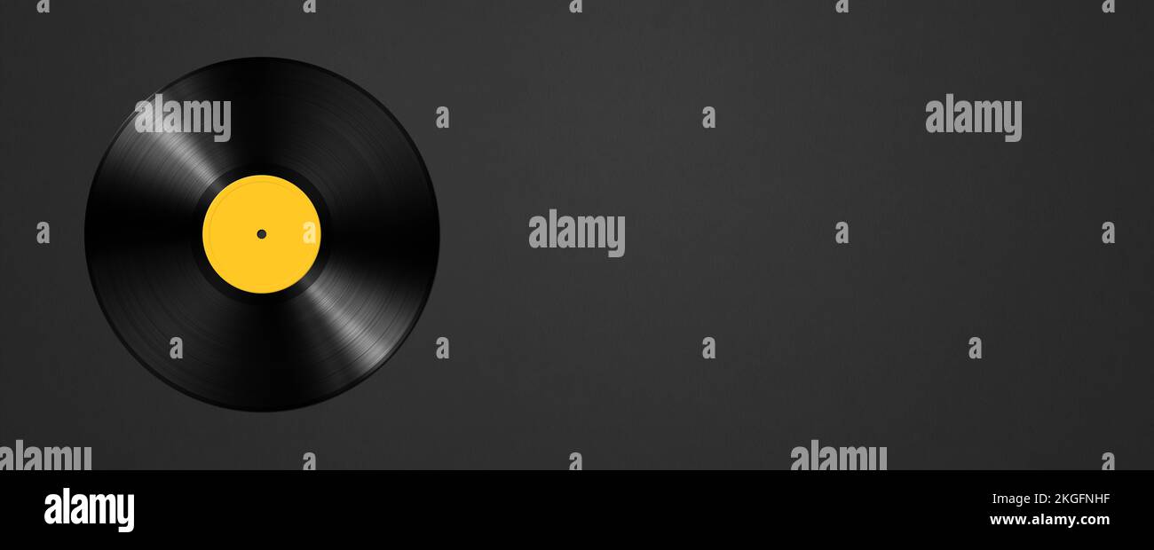 Yellow vinyl record isolated on black background. Horizontal banner. 3D