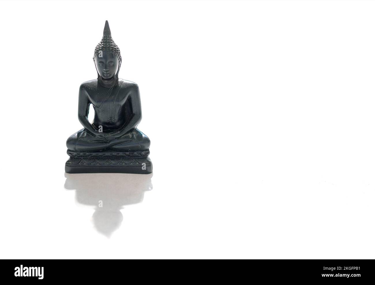 Black stone Buddha Figure Isolated On White background Stock Photo