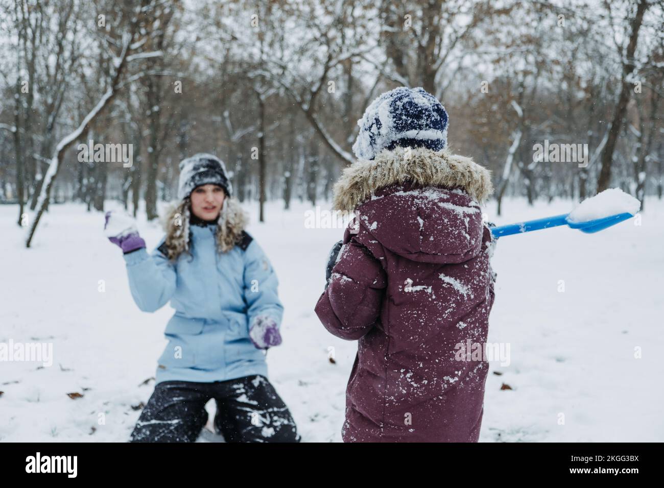 Outdoor winter activities for kids and family. Let it snow. Happy family Mom and kid boy having