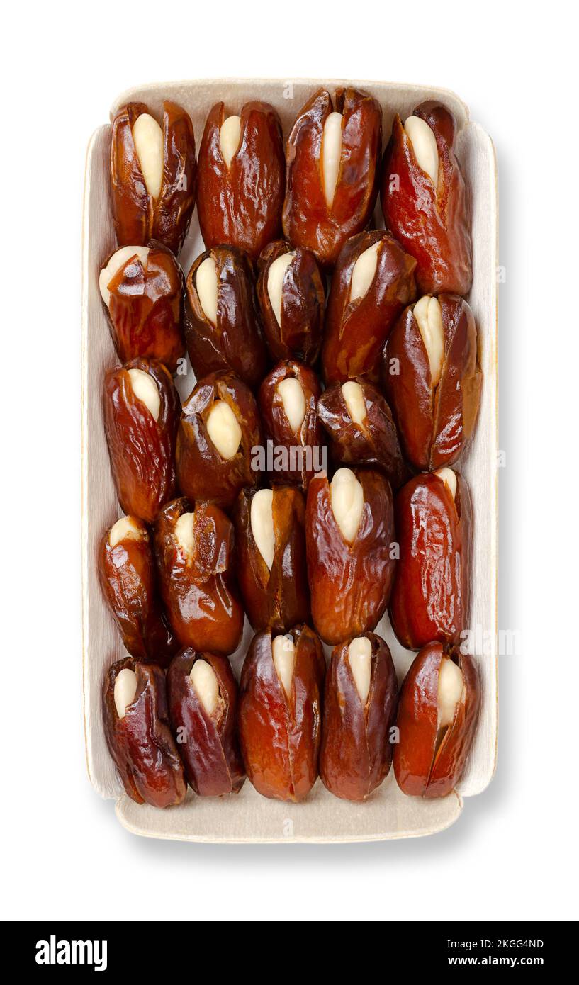 Almond-stuffed dates, in a balsa wood tray, from above. Sun dried Deglet Nour dates, pitted and filled with whole blanched almonds. Stock Photo