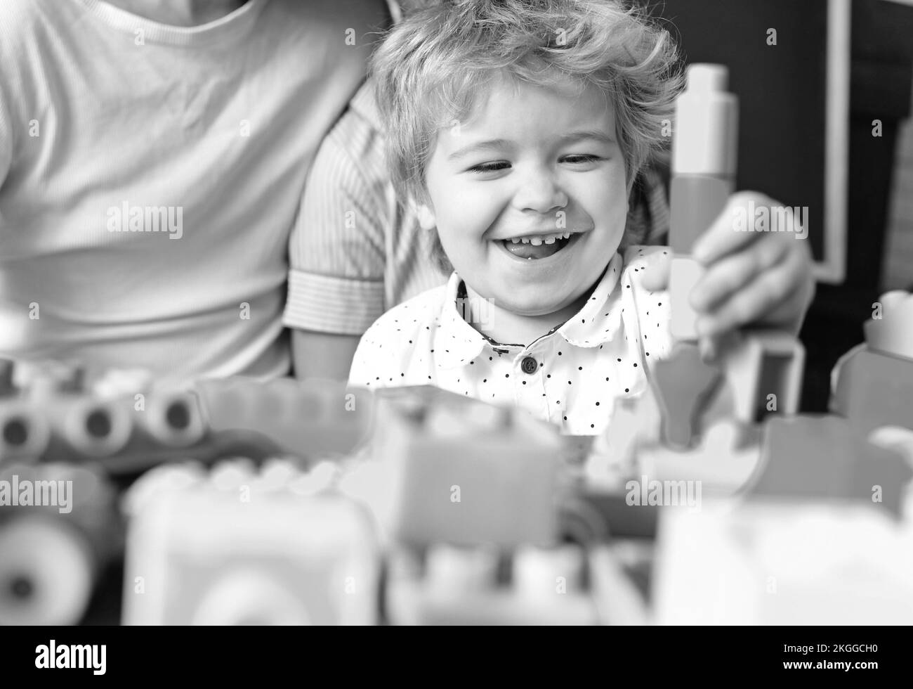 Boy spends fun time in playroom. Child with cheerful face Stock Photo