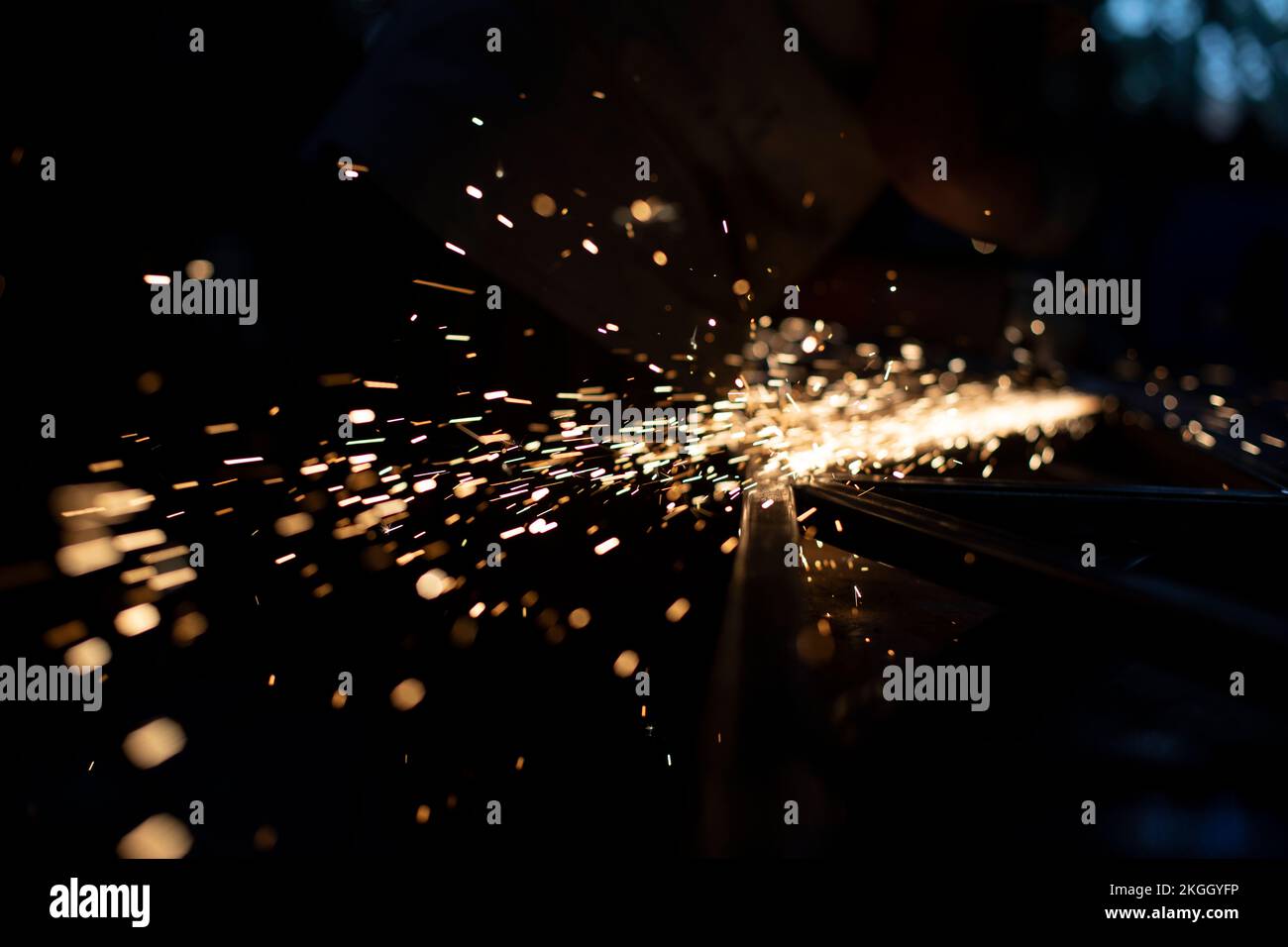Metal grinding. Sparks from friction. Lights in dark. Chaotic flight of