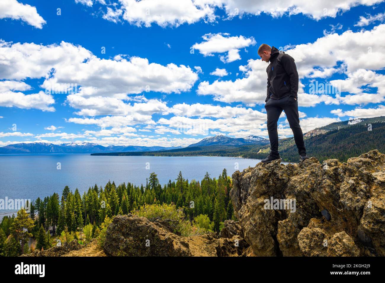 Hiker enjoying the view of Lake Tahoe from the Eagle Rock in California Stock Photo