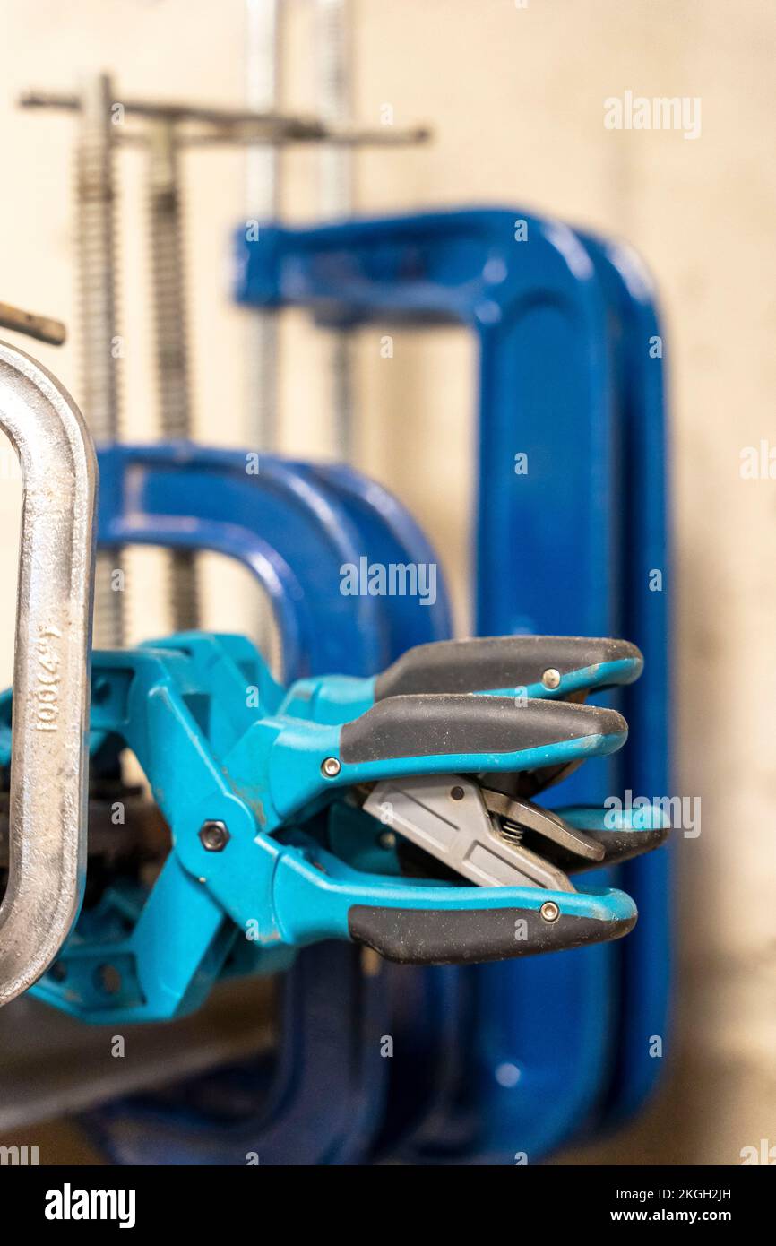 hand clamps on the welding table in the auto repair shop Stock Photo