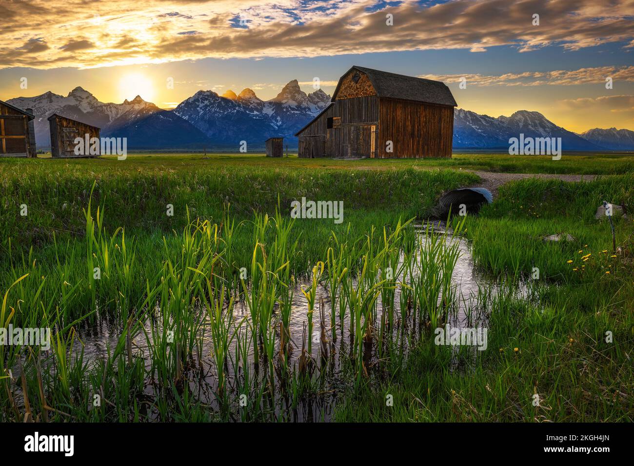 Sunset over a historic barn at Mormon Row in Grand Teton National Park, Wyoming Stock Photo