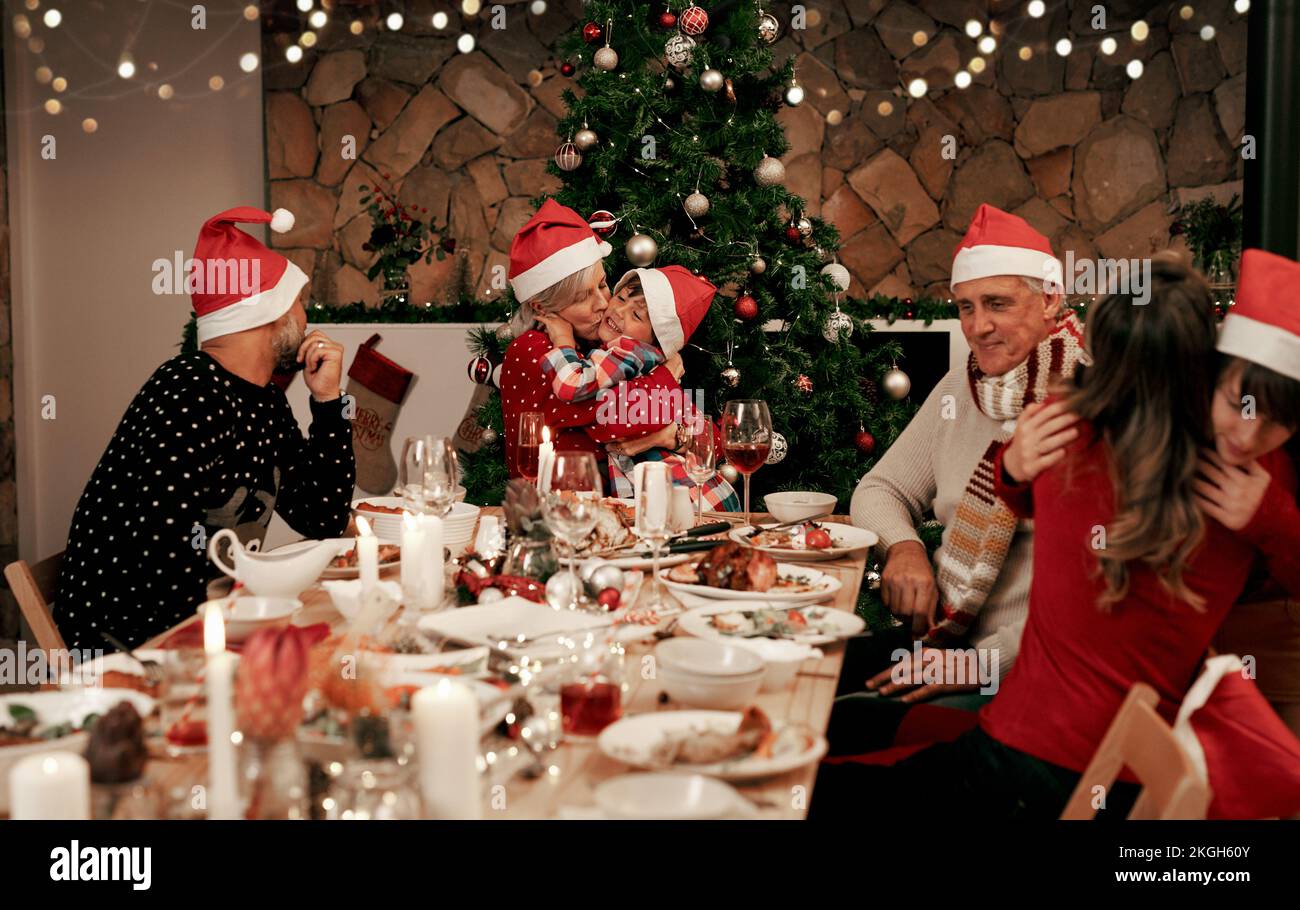 Family, generations and Christmas dinner party with men, women and children smile, eat and drink together in dining room. Happy family, kids, couple Stock Photo