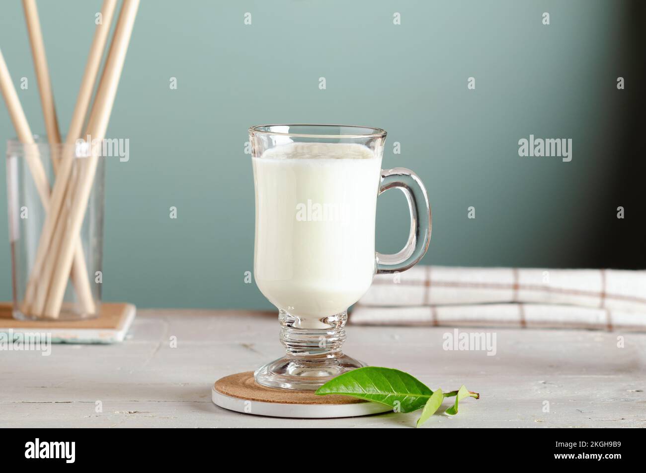 Kefir, fermented milk drink or yogurt in a glass on white wooden background. Stock Photo