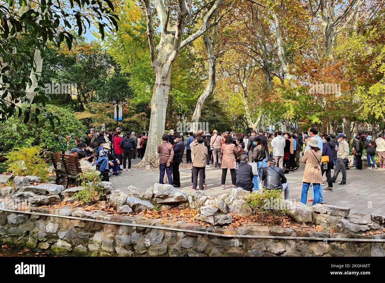 SHANGHAI, CHINA - NOVEMBER 23, 2022 - Elderly people chat to find dates for their children at Lu Xun Park in Shanghai, China, November 23, 2022. It is Stock Photo