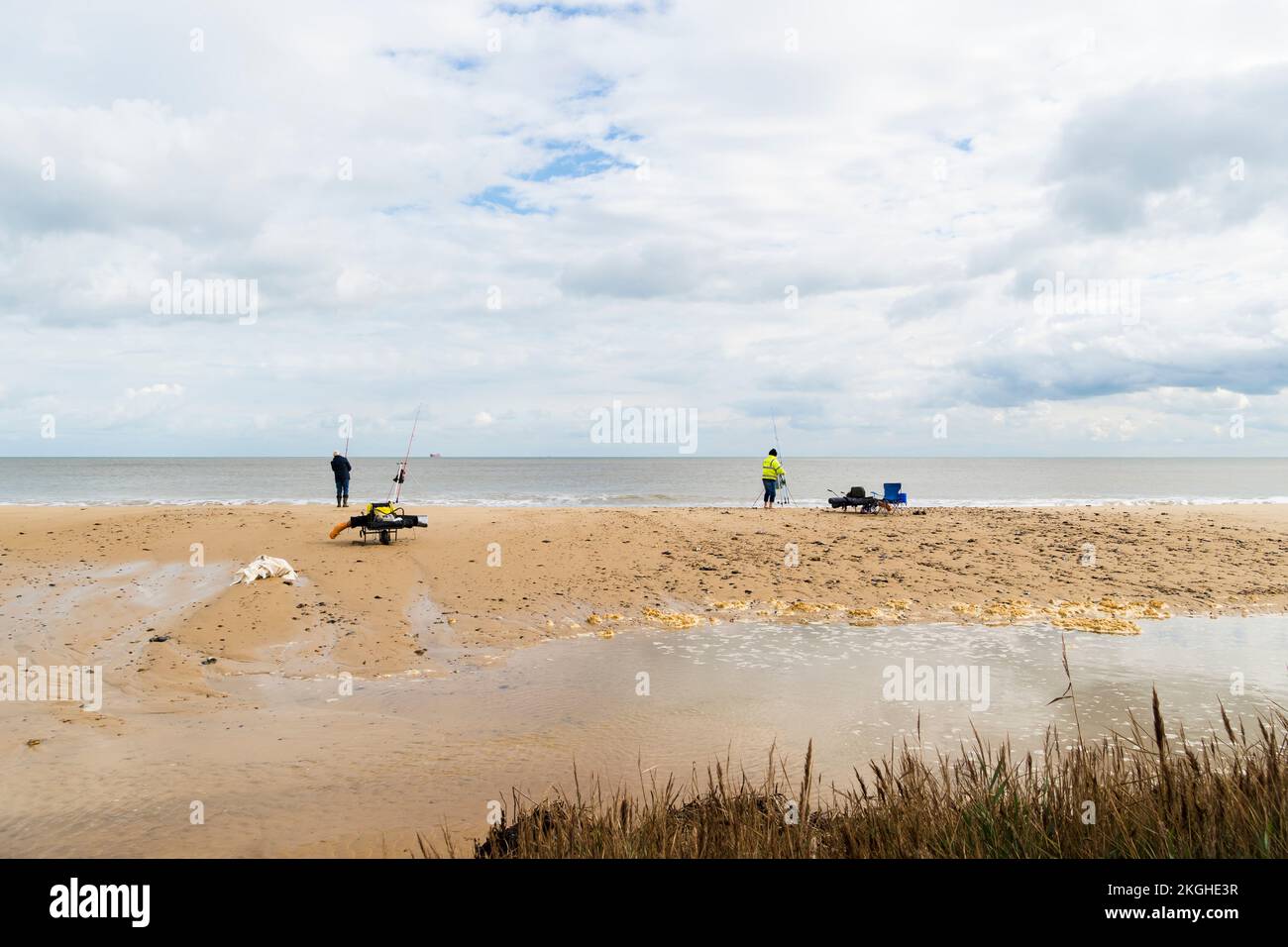 Two sea anglers fishing off Covehithe beach Suffolk 2022 Stock Photo