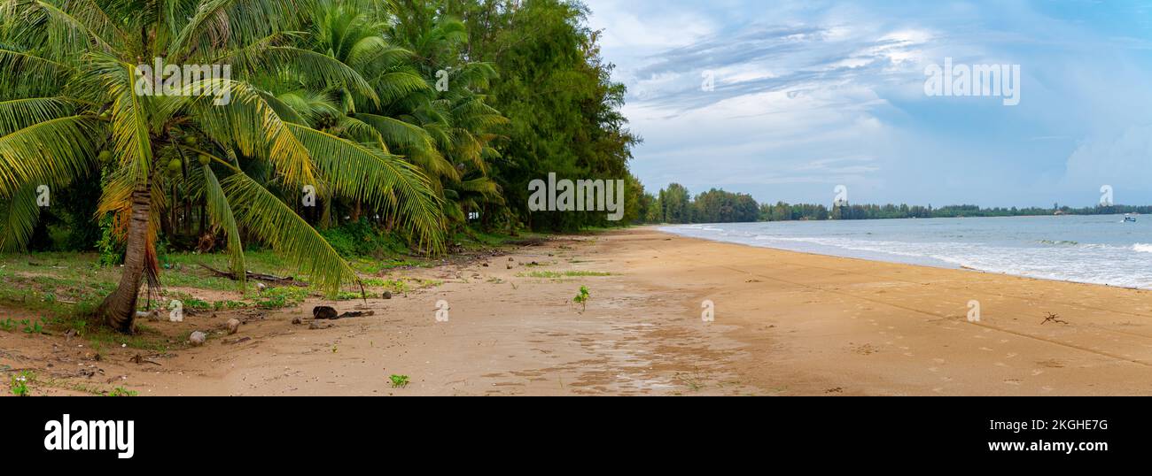 Wild beach at the sea of Thailand Chumphon area with coconut and palm trees with very fine sand both on land and in the water and in the background a Stock Photo