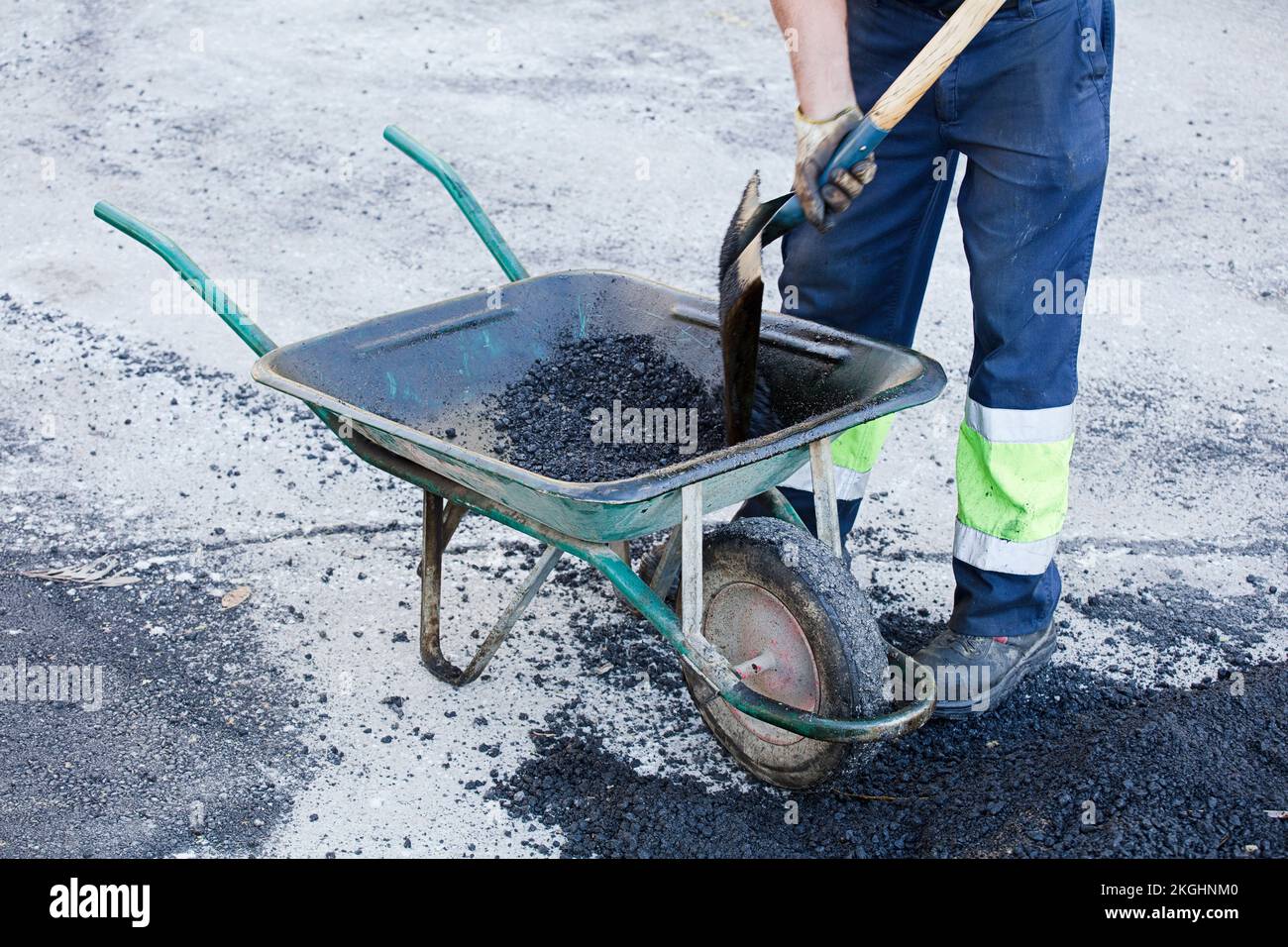 asphalt in wheelbarrow operator prepares mixture with uniform Stock ...