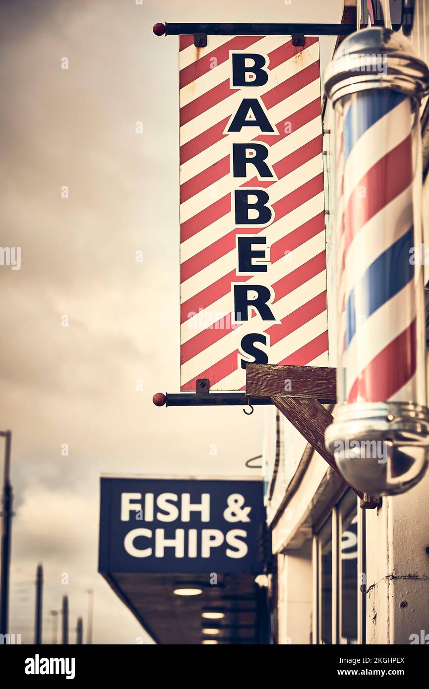 Barber shop and fish and chips shop signs on Fleetwood front Stock Photo