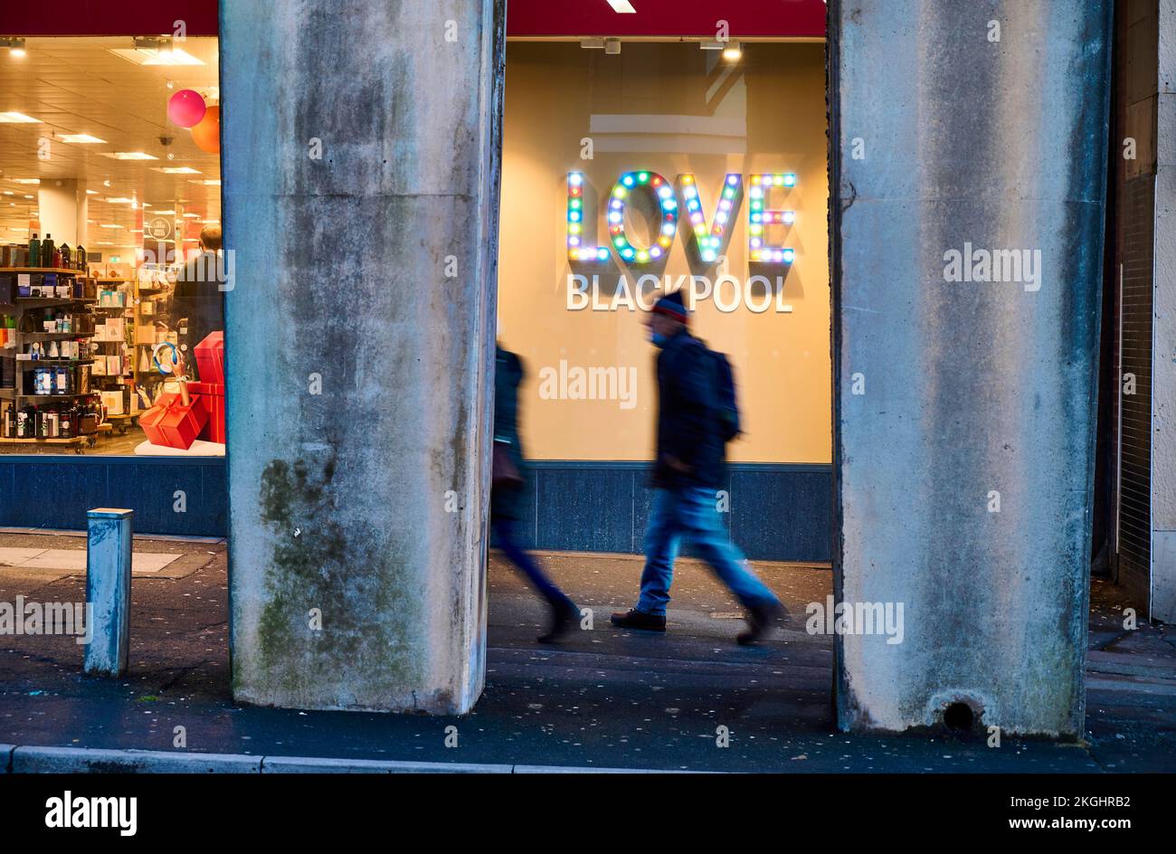 Illuminated Love Blackpool sign in town centre shop window at night