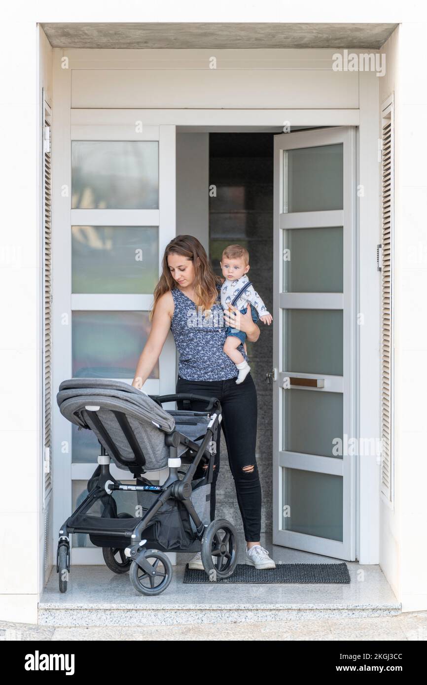 Mother and her son at the door of their house ready to go Stock Photo