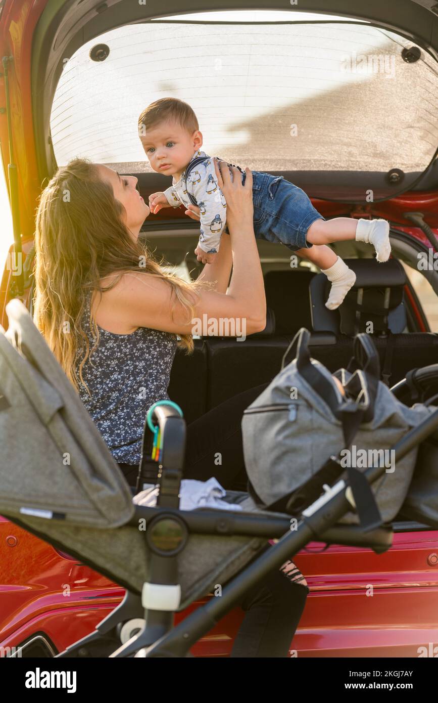 mother with her son playing in the back of the car Stock Photo