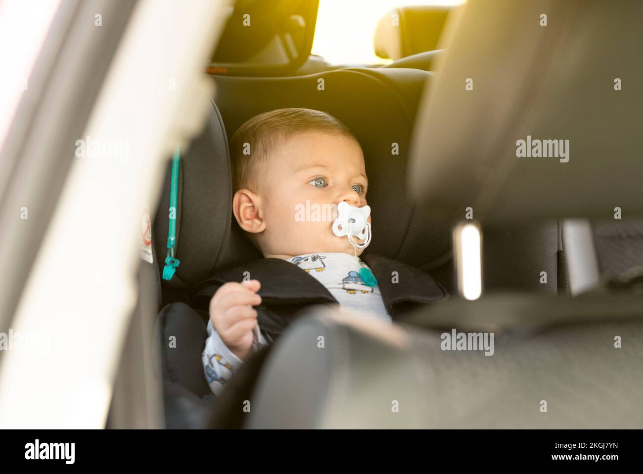 Baby in the car seat with a pacifier Stock Photo Alamy