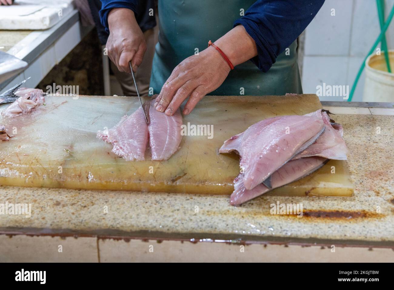 Vendor preparing fish at the Central Market (Mercado Central) in Santiago de Chile Stock Photo