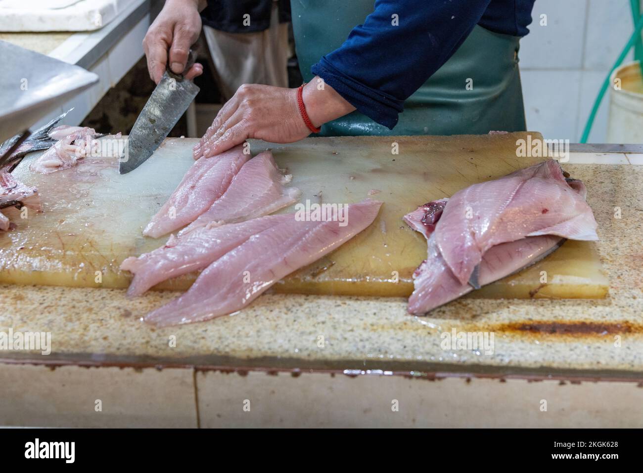 Vendor preparing fish at the Central Market (Mercado Central) in Santiago de Chile Stock Photo