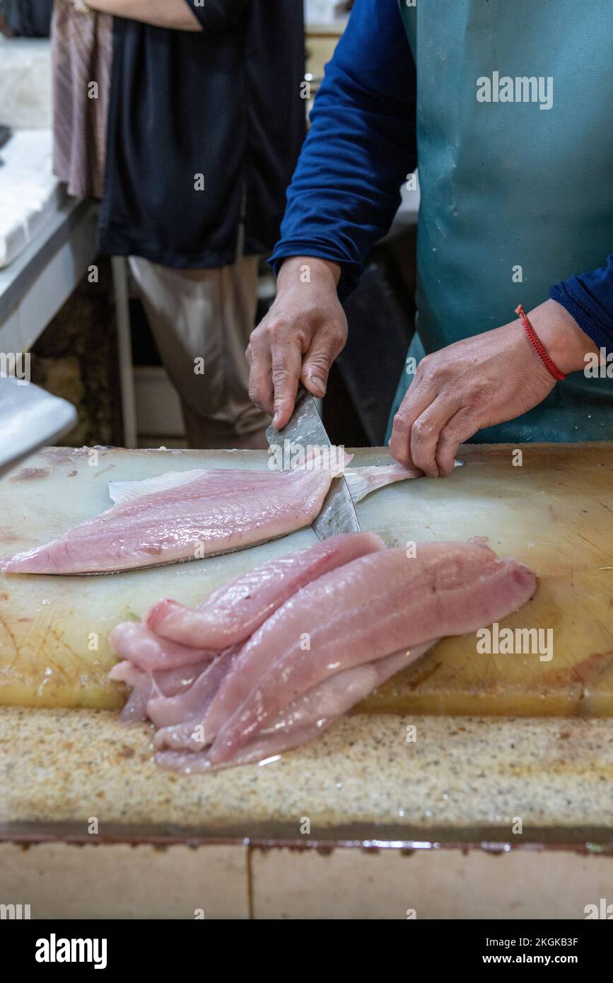 Vendor preparing fish at the Central Market (Mercado Central) in Santiago de Chile Stock Photo