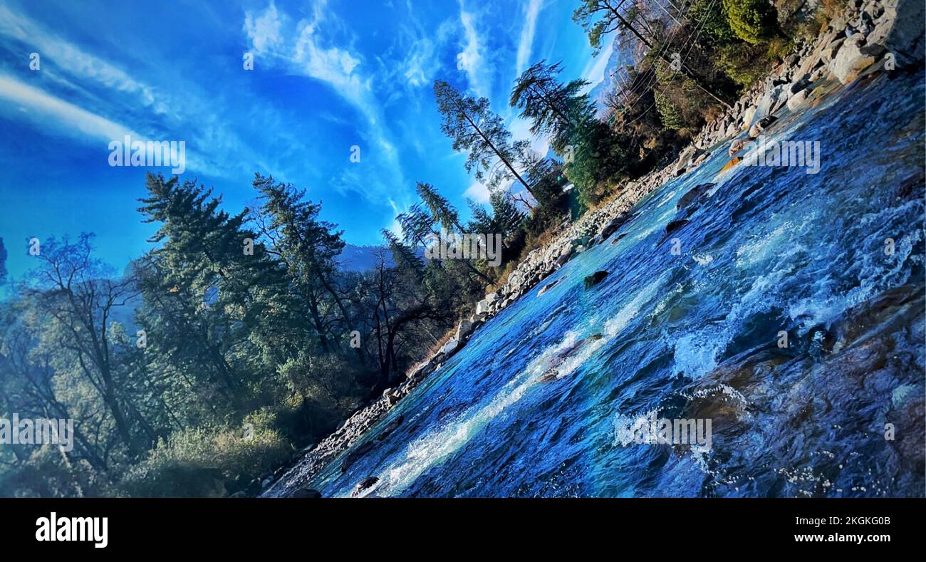 Kasol waterfall dancing clouds and pine tress all together Stock Photo